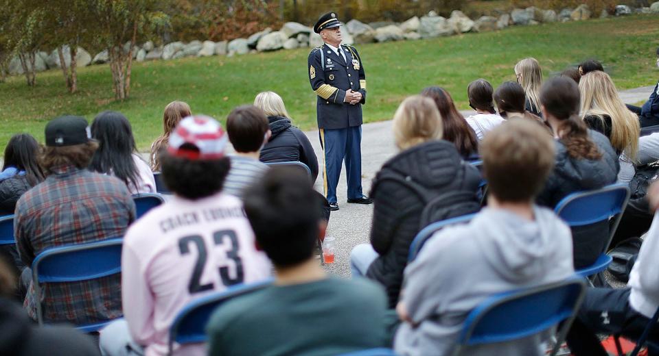 Retired U.S. Army 1st Sgt. John Bourne, of Rockland, talks with history students at Braintree High about his 27 years of service.