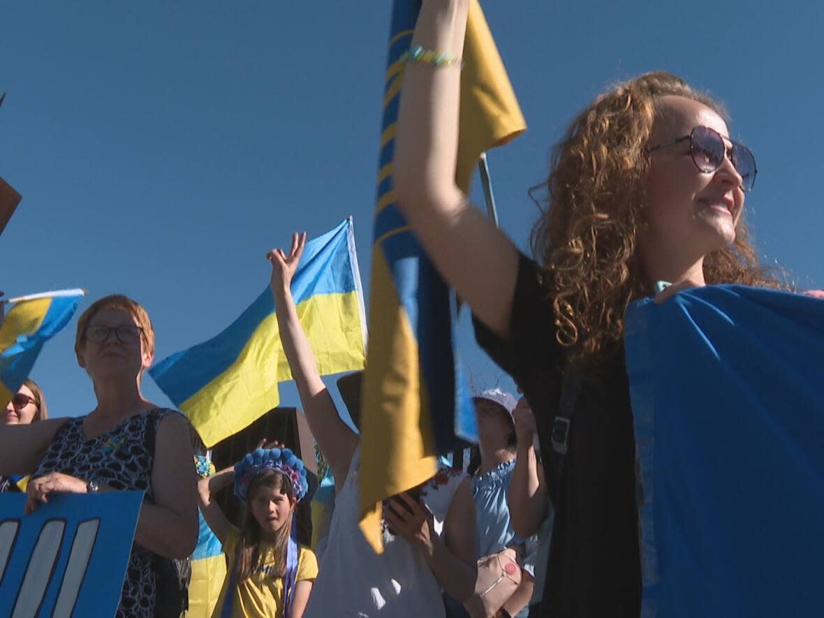 Calgarians rallied on Aug. 7, 2022 in support of Ukrainians suffering through the effects of war.  (Terri Trembath/CBC - image credit)