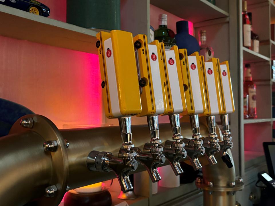 Beer taps at Lincoln Yard bar are depict school buses.
