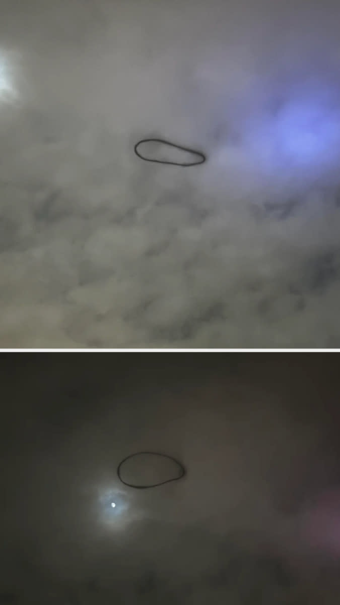 A dark, ring-shaped object hangs in the cloudy sky, appearing both during daytime and nighttime