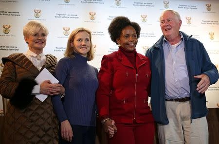 Catherine McGowan (2nd L), wife of South African Stephen McGowan (not pictured), who was kidnapped by al Qaeda from the Mali tourist town of Timbuktu in 2011 and has been released and is back home, poses for a photograph with foreign minister Maite Nkoana-Mashabane, Malcom McGowan, father of Stephen, and Sue Peisier, Stephen's mother-in-law, after a media briefing in Pretoria, South Africa August 3, 2017. REUTERS/Siphiwe Sibeko