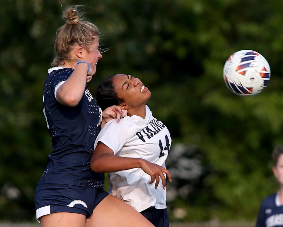 Cohasset's Meghan Smith and East Bridgewater's Calice Morton battle for the 50/50 ball in the midfield during second half action of their game at Cohasset High School on Wednesday, Sept. 27, 2023. Cohasset would go on to win 4-1.