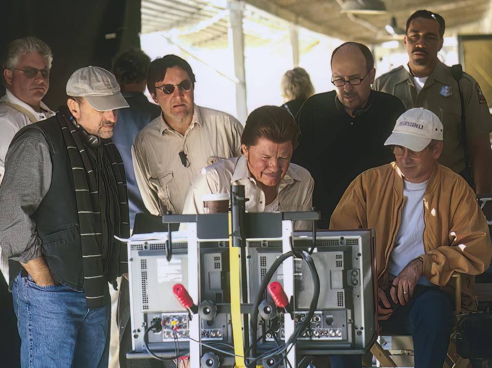 cast and crew of holes watching a scene being filmed via a monitor on set