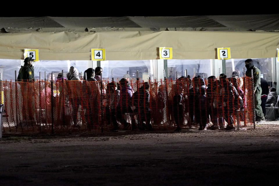 FILE - In this Friday, March 19, 2021, photo migrants are seen in custody at a U.S. Customs and Border Protection processing area under the Anzalduas International Bridge, in Mission, Texas. The Biden administration is facing growing questions about why it wasn't more prepared for an influx of migrants at the southern border. The administration is scrambling to build up capacity to care for 14,000 young undocumented migrants now in federal custody — and more likely on the way. (AP Photo/Julio Cortez, File)