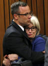 Oscar Pistorius and his aunt Lois Pistorius, right, hug after the prosecution closed it case in court in Pretoria, South Africa, Tuesday, March 25, 2014. Pistorius is charged with the Valentines Day 2013 shooting death of his girlfriend Reeva Steenkamp. The trial will resume Friday. (AP Photo/Siphiwe Sibeko, Pool)