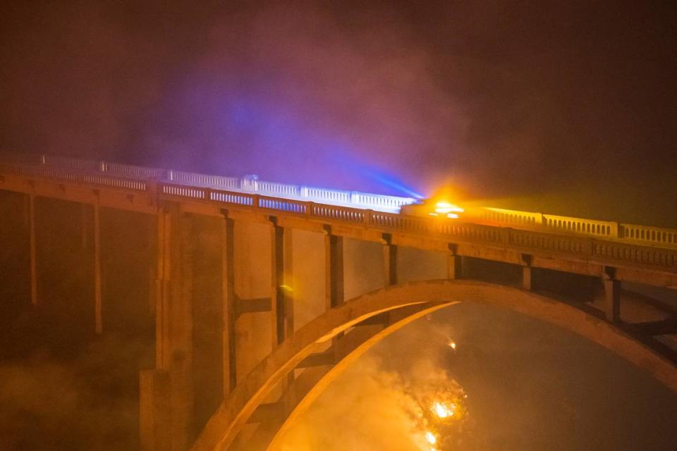 The Colorado Fire burns under Rocky Creek Bridge on Highway 1 near Big Sur, Calif., Saturday, Jan. 22, 2022. (AP Photo/Nic Coury)