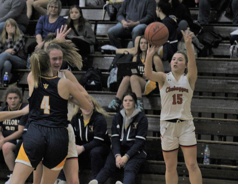 Cheboygan senior point guard Cassidy Jewell (15) fires up a shot during the second quarter of a varsity girls basketball matchup against Gaylord in Cheboygan on Thursday.