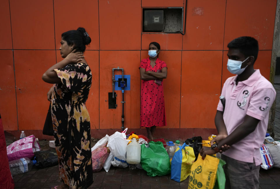People wait in a queue at a fuel station hoping to buy kerosene oil in Colombo, Sri Lanka, Saturday, June 11, 2022. Sri Lanka's prime minister says he may be compelled to buy more oil from Russia as he hunts desperately for more fuel to keep the country running. In an interview with The Associated Press on Saturday, Prime Minister Ranil Wickremesinghe said if the island nation can get the oil from other sources, it will. (AP Photo/Eranga Jayawardena)