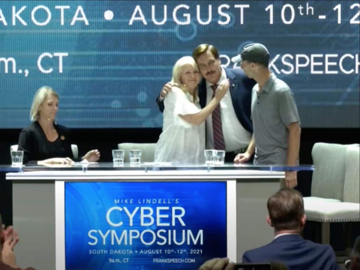 MyPillow CEO Mike Lindell hugs Mesa County clerk Tina Peters during a “cyber symposium” discussing 2020 election conspiracy theories. (screengrab)