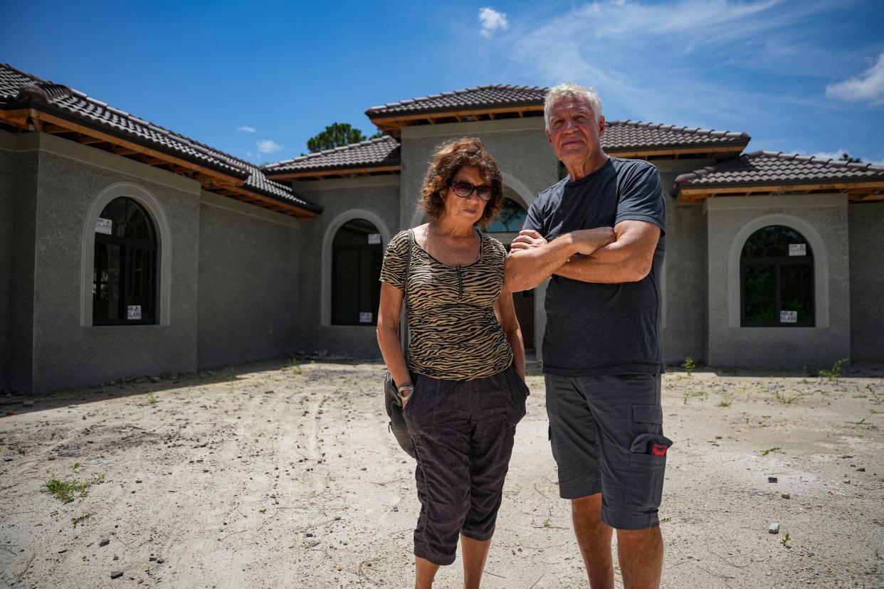 Lucy and Boris Deriy pose for a photo at a Metro Home Builders construction site in Naples on Tuesday, Aug. 15, 2023. The couple say the company took 75% of the money for the home and left it unfinished.