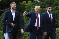 President Donald Trump flanked by Red Sox players Chris Sale, left, and J. D. Martinez, walk on the South Lawn during a ceremony welcoming the 2018 World Series baseball champions to the White House, the Boston Red Sox, Thursday, May 9, 2019, in Washington. (AP Photo/Manuel Balce Ceneta)