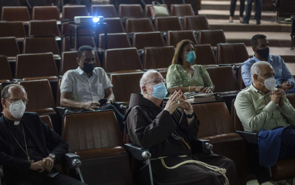 The Archbishop of Boston, Cardinal Sean Patrick O'Malley, center, listens to a presentation at Cuba's Genetic Engineering and Biotechnology Center where the island's locally developed COVID-19 vaccines are made in Havana, Cuba, Thursday, Sept. 9, 2021. (AP Photo/Ramon Espinosa)