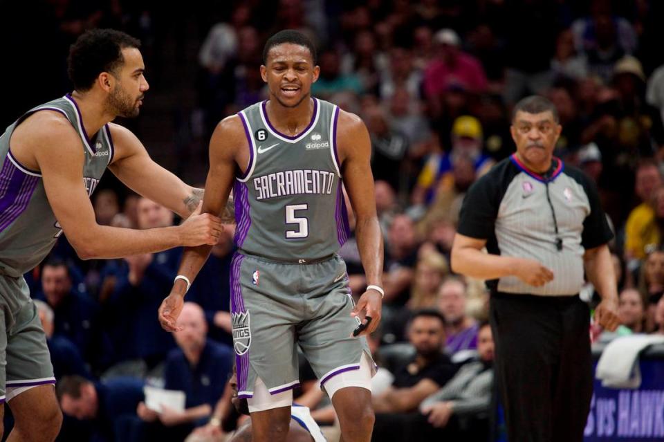 Sacramento Kings guard De’Aaron Fox (5) is supported by Trey Lyles as he reacts to being called for a foul against Golden State Warriors forward Draymond Green during Game 5 of the first-round NBA playoff series at Golden 1 Center on Wednesday.