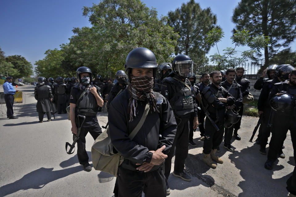 Riot police officers stand guard outside a court where former Prime Minister Imran Khan appeared for his case, in Islamabad, Pakistan, Monday, March 27, 2023. A Pakistani court ruled in defense of former Prime Minister Khan, granting him protection from arrest as lawsuits mounted against the ousted premier, with police charging him with incitement to violence in several cases when his followers clashed with the security forces this month. (AP Photo/Anjum Naveed)