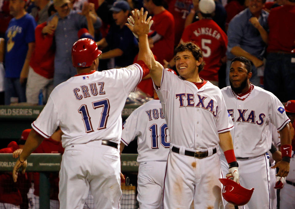 ARLINGTON, TX - OCTOBER 24: Nelson Cruz #17, Ian Kinsler #5 and Elvis Andrus #1 of the Texas Rangers celebrate after Cruz scored on a two-run double by Mike Napoli #25 in the eighth inning during Game Five of the MLB World Series against the St. Louis Cardinals at Rangers Ballpark in Arlington on October 24, 2011 in Arlington, Texas. (Photo by Tom Pennington/Getty Images)