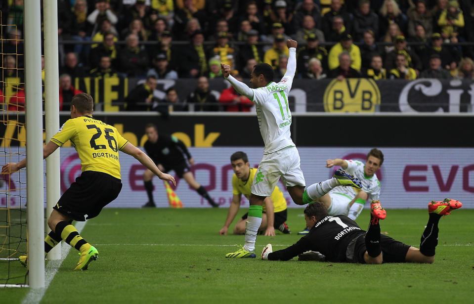 Moenchengladbach's Raffael of Brazil, center, celebrates after scoring during the German first division Bundesliga soccer match between BvB Borussia Dortmund and VfL Borussia Moenchengladbach in Dortmund, Germany, Saturday, March 15, 2014. (AP Photo/Frank Augstein)