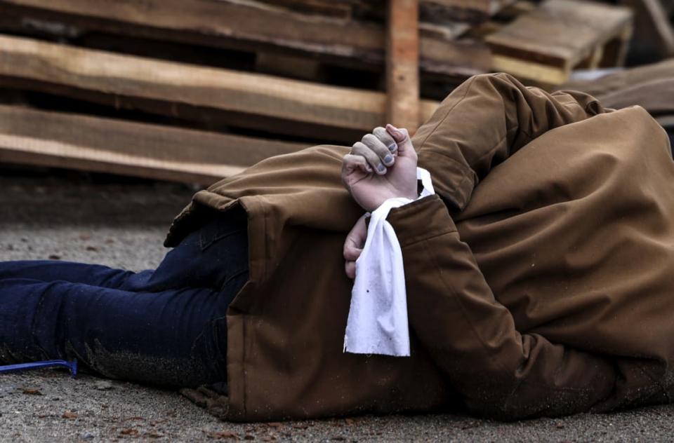 <div class="inline-image__caption"><p>The body of a man, with his wrists tied behind his back, lies on a street in Bucha.</p></div> <div class="inline-image__credit">Ronaldo Schemidt/AFP via Getty</div>