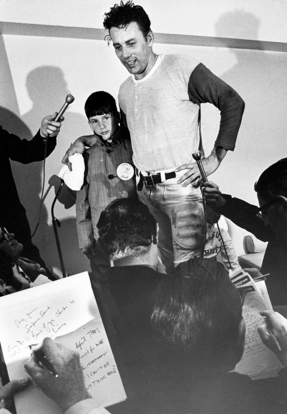 Kansas City quarterback Len Dawson and his son Len Jr. meet the press after the Chiefs' 23-7 win over the Minnesota Vikings in Super Bowl IV at Tulane Stadium, Jan. 11, 1970. Dawson was named MVP of the game.