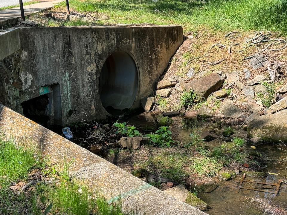 A storm drain under a road in Greenville, South Carolina, holds a pool of water.