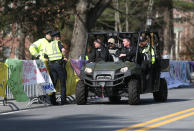 Police officers give a rundown of the scene at Wellesley College to a State Police Special Response team before the start of the 118th Boston Marathon Monday, April 21, 2014 in Wellesley. (AP Photo/Mary Schwalm)