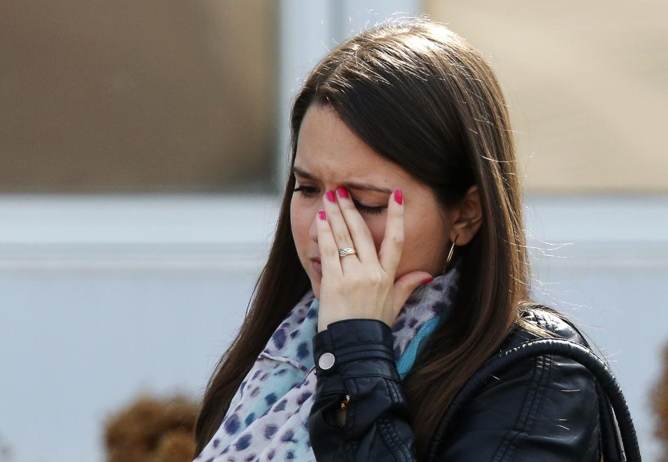 A woman leaves the funeral of Jordan Segura in Calgary, Alberta April 21, 2014. Matthew de Grood has been charged with killing Segura and four of his friends at a house party last week in Calgary's worst mass murder in the history of the city, according to local media reports. REUTERS/Todd Korol (CANADA - Tags: CRIME LAW OBITUARY)