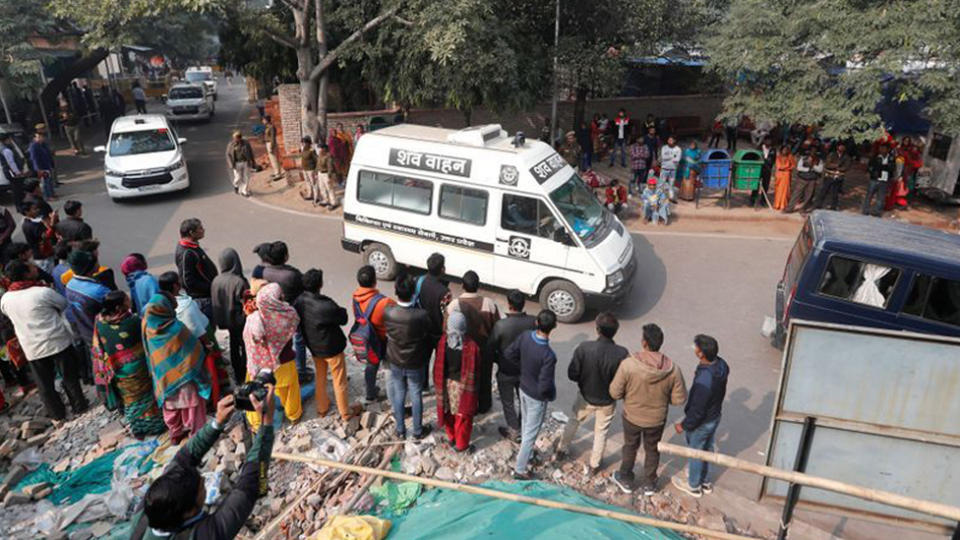 A hospital vehicle carries the body of a rape victim