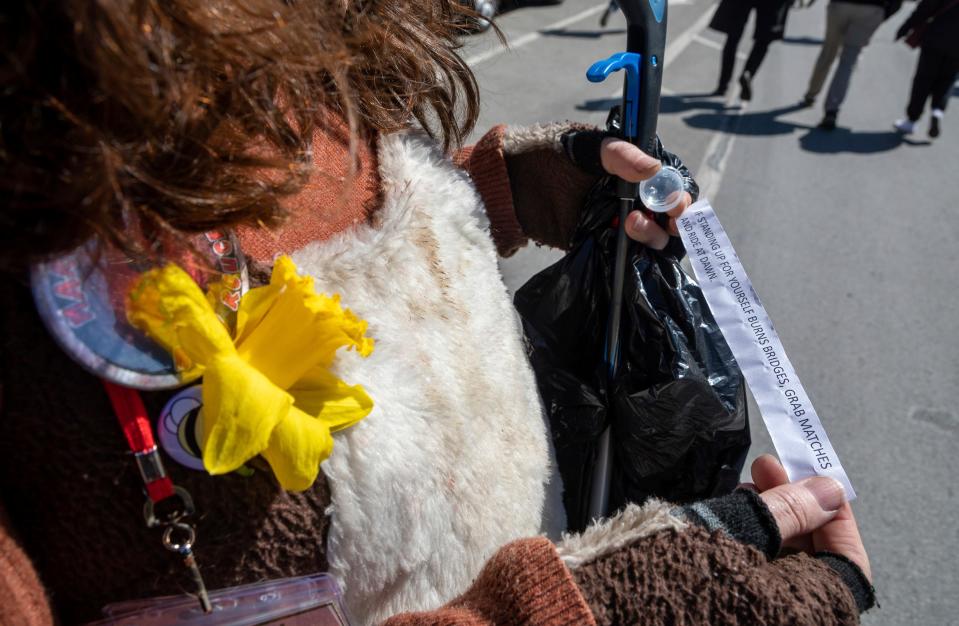 Lynn Blasey, 40, program manager of the Community Arts Partnerships office at the College for Creative Studies, reads a words of affirmation note given to her during the Marche du Nain Rouge 2024 parade in Detroit on Sunday, March 24, 2024.