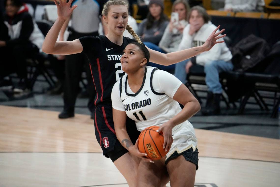 Colorado center Quay Miller (11) and Stanford forward Cameron Brink (22) in the second half of an NCAA college basketball game Thursday, Feb. 23, 2023, in Boulder, Colo. (AP Photo/David Zalubowski)