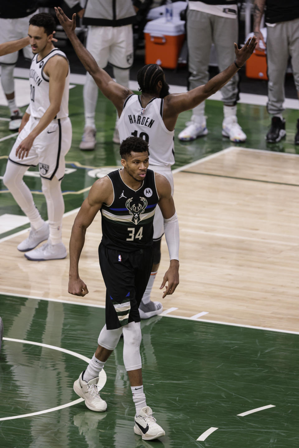 Milwaukee Bucks forward Giannis Antetokounmpo (34) walks away after scoring and being fouled by Brooklyn Nets' James Harden during the second half of Game 6 of a second-round NBA basketball playoff series Thursday, June 17, 2021, in Milwaukee. (AP Photo/Jeffrey Phelps)