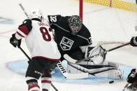 Arizona Coyotes right wing Conor Garland, left, tries to get a shot past Los Angeles Kings goaltender Jonathan Quick during the first period of an NHL hockey game Wednesday, March 3, 2021, in Los Angeles. (AP Photo/Mark J. Terrill)