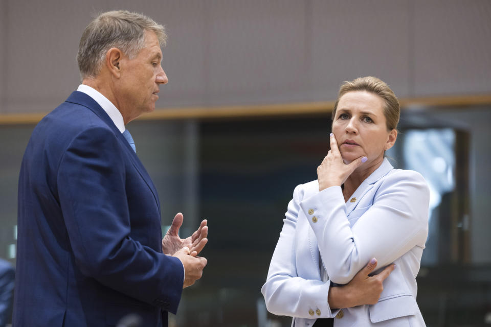 Denmark's Prime Minister Mette Frederiksen, right, speaks with Romania's President Klaus Werner Ioannis during a round table meeting at an EU summit in Brussels, Thursday, June 29, 2023. European leaders meet for a two-day summit to discuss Ukraine, migration and the economy. (AP Photo/Geert Vanden Wijngaert)