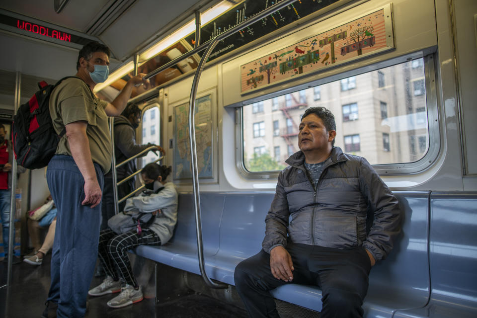 Ecuadorian immigrant Neptali Chiluisa rides the subway as he returns from his temporary job in the borough of Bronx on Monday, Oct. 25, 2021, in New York. (AP Photo/Eduardo Munoz Alvarez)