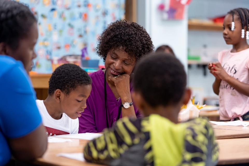 Forest Park Elementary School teacher Melinda Jackson listens to second grader Ny'Jel Davis-Singleton read to her after a writing assignment in the resource room at the school in Eastpointe on Monday, June 10, 2019. A bill introduced in the Michigan House of Representatives would strongly recommend schools to adopt plans to instruct cursive handwriting to their students.