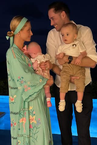 <p>Paris hilton/ Instagram</p> Paris Hilton (left) holds daughter London and Carter Reum holds son Phoenix