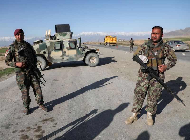 FILE PHOTO: Afghan National Army (ANA) soldiers stand guard at a check point near the Bagram Airbase north of Kabul, Afghanistan
