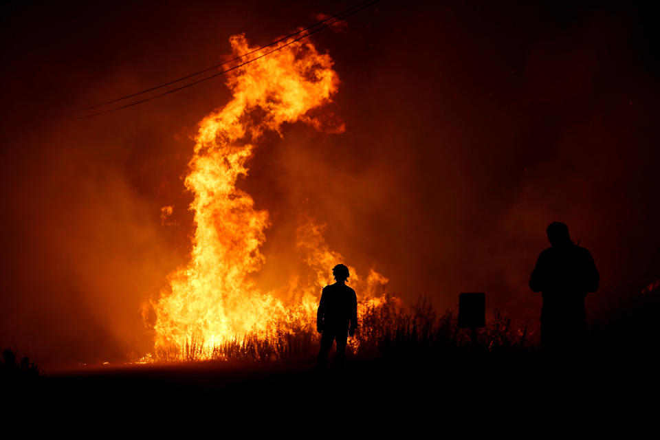 <p>Firefighters work to put out a forest fire next to the village of Macao, near Castelo Branco, Portugal, July 26, 2017. (Rafael Marchante/Reuters) </p>