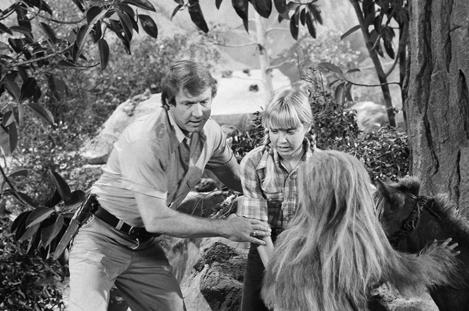 LAND OF THE LOST, (from left) Ron Harper, Kathy Coleman, Philip Paley (as Cha-Ka, back to camera), 1974-77.
