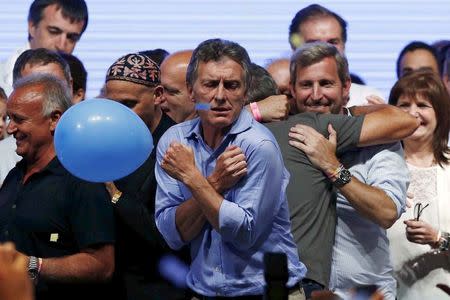 Mauricio Macri, presidential candidate of the Cambiemos (Let's Change) coalition, dances on stage after the presidential election in Buenos Aires, November 22, 2015. REUTERS/Ivan Alvarado