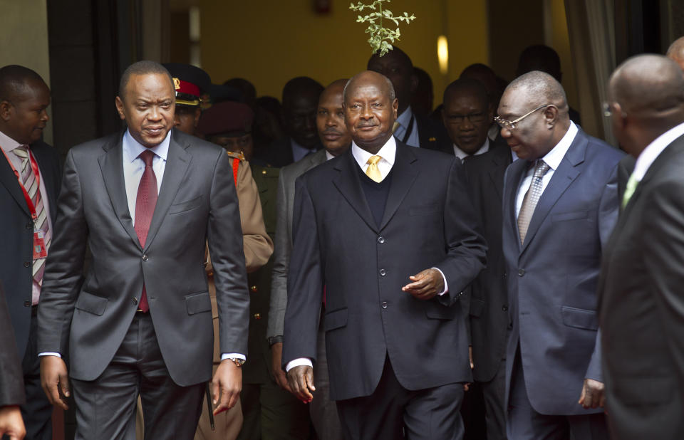 FILE - In this Wednesday, July 31, 2013, file photo, Kenya's President Uhuru Kenyatta, left, Uganda's President Yoweri Museveni, center, and the transitional leader of the Central African Republic Michel Djotodia, right, arrive for the Special Summit of the International Conference on the Great Lakes Region (ICGLR) held at the United Nations Office in Nairobi, Kenya. Ugandan President Yoweri Museveni met in his office with a team of U.S.-based rights activists concerned about legislation that would impose life sentences for some homosexual acts and made clear he had no plans to sign the bill, according to Santiago Canton of the Robert F. Kennedy Center for Justice and Human Rights who attended the Jan. 18, 2014 meeting, but one month later Museveni appears to have changed his mind, saying through a spokesman in February 2014 that he would sign the bill "to protect Ugandans from social deviants." (AP Photo/Ben Curtis, File)