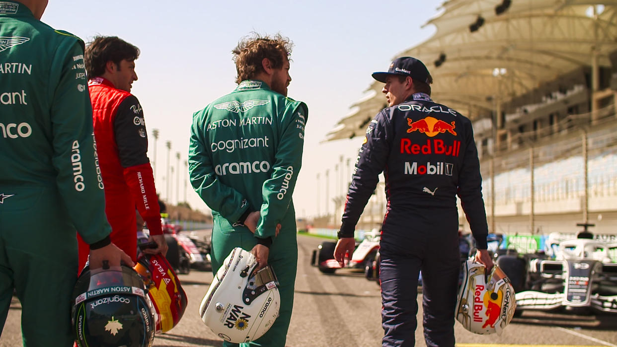 Sebastian Vettel of Aston Martin speaks to Max Verstappen of Red Bull in a still from 