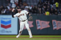 San Francisco Giants third baseman David Villar throws to first for the out on Colorado Rockies' C.J. Cron during the fourth inning of a baseball game in San Francisco, Wednesday, Sept. 28, 2022. (AP Photo/Godofredo A. Vásquez)
