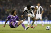 <p>Juventus’ Dani Alves in action with Real Madrid’s Marcelo </p>