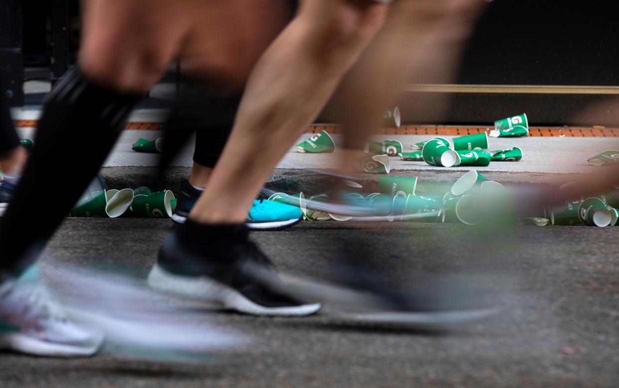 Runners make their way down 7th street around the five file marker during the 2022 Flying Pig Marathon in downtown Cincinnati on Sunday, May 1, 2022. Gatorade, water and lots of encouragement were offered.