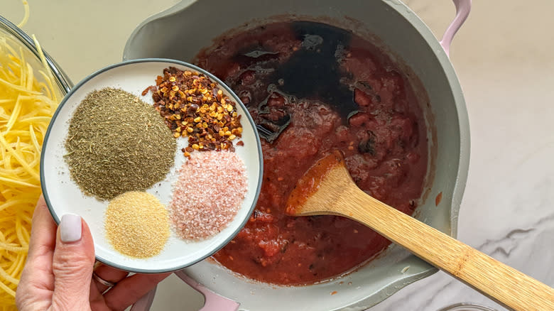 adding spices to pot