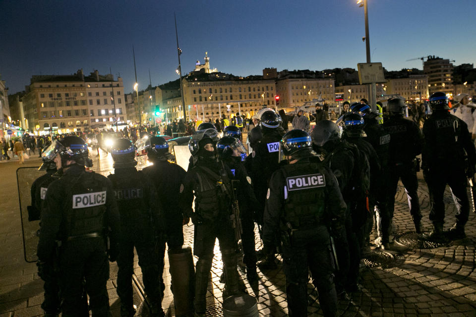 French riot police take positions in the city center during a yellow vest demonstration in Marseille, southern France, Saturday, Jan. 12, 2019. The French Interior Ministry says about 32,000 people have turned out in yellow vest demonstrations across France, including 8,000 in Paris, where scuffles broke out between protesters and police. (AP Photo/Claude Paris)