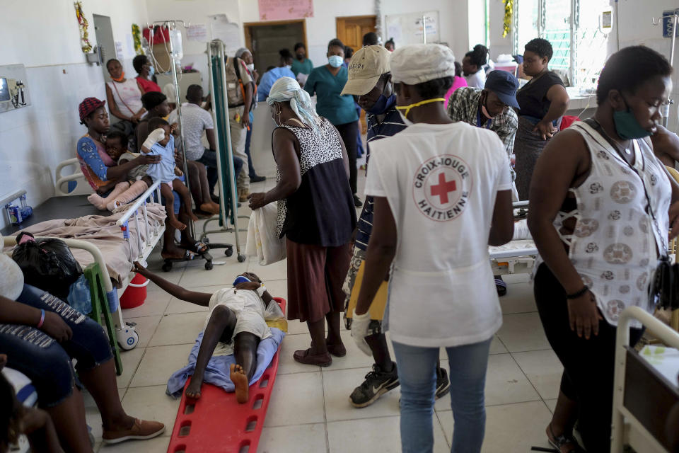 People injured in Saturday's 7.2-magnitude earthquake and their relatives, crowd in an emergency room at the Saint Antoine hospital in Jeremie, Haiti, Wednesday, Aug. 18, 2021. (AP Photo/Matias Delacroix)