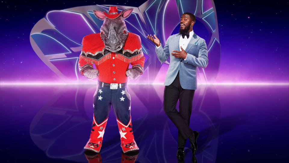 This image and the information contained herein is strictly embargoed until Sunday 18 December 2022 at 8pm ITV Plc/Van Bandicoot TV The Masked Singer: SR4 on ITV1 and ITVX Pictured: Rhino and Mo Gilligan.  This photograph is (C) ITV Plc/Bandicoot TV and may only be reproduced for editorial purposes, directly in connection with the program or event referred to above, or ITV plc.  Once made available by ITV plc Picture Desk, this picture can only be reproduced once until dispatch [TX] date and no reproduction fee will be charged.  Charges may apply for each subsequent use.  This photo should not be manipulated [excluding basic cropping] in any way that alters the visual appearance of the person being photographed and is considered harmful or inappropriate by ITV plc Picture Desk.  This photograph may not be syndicated to any other company, publication or website, or permanently archived, without the express written permission of ITV Picture Desk.  Full terms and conditions are available on the website www.itv.com/presscentre/itvpictures/terms For more information, please contact: james.hilder@itv.com