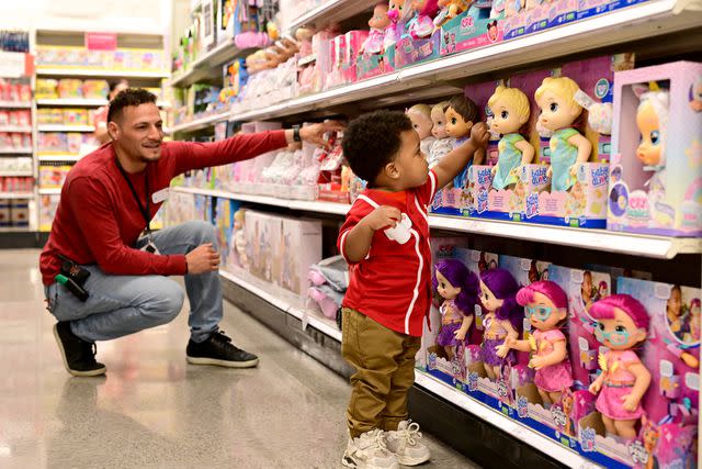 <p>Grant Halverson/Getty Images for Target</p> Azai examining inventory in the toy department