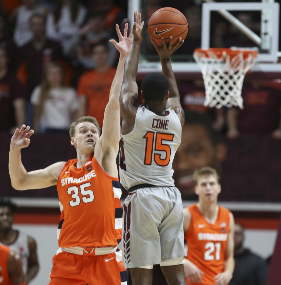 Virginia Tech's Jalen Cone (15) shoots over the defense Syracuse's Buddy Boeheim (35) during the first half of an NCAA college basketball game in Blacksburg Va., Saturday, Jan. 18 2020. (Matt Gentry/The Roanoke Times via AP)