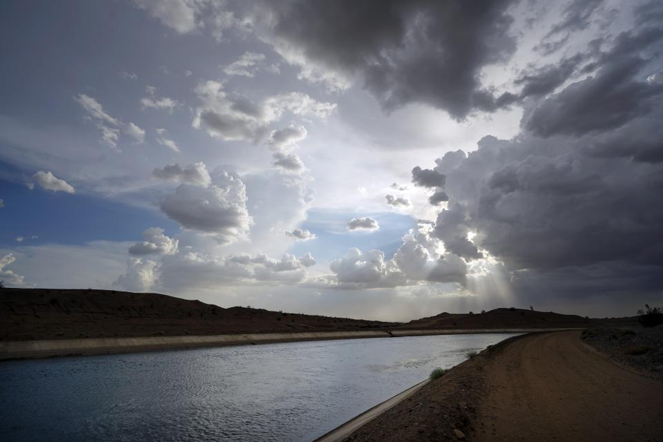 FILE - Water flows along the All-American Canal Saturday, Aug. 13, 2022, near Winterhaven, Calif. The canal conveys water from the Colorado River into the Imperial Valley. Competing priorities, outsized demands and the federal government's retreat from a threatened deadline all combined to thwart a voluntary deal last summer on how to drastically cut water use from the parched Colorado River, according to emails obtained by The Associated Press. (AP Photo/Gregory Bull, File)